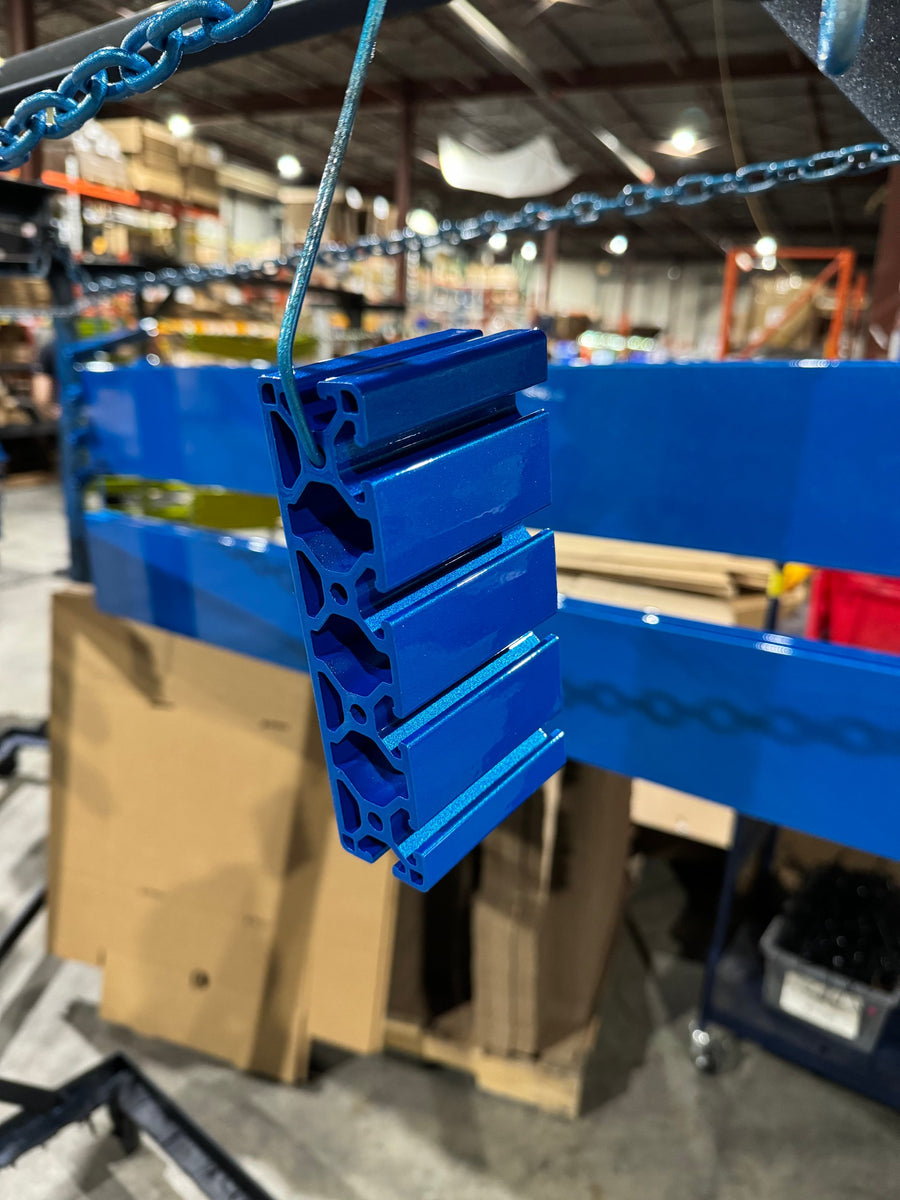 Aluminum extrusions powder coated in blue hanging in the warehouse