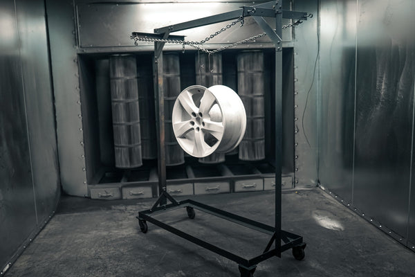 Purple powder-coated wheel in the spray booth