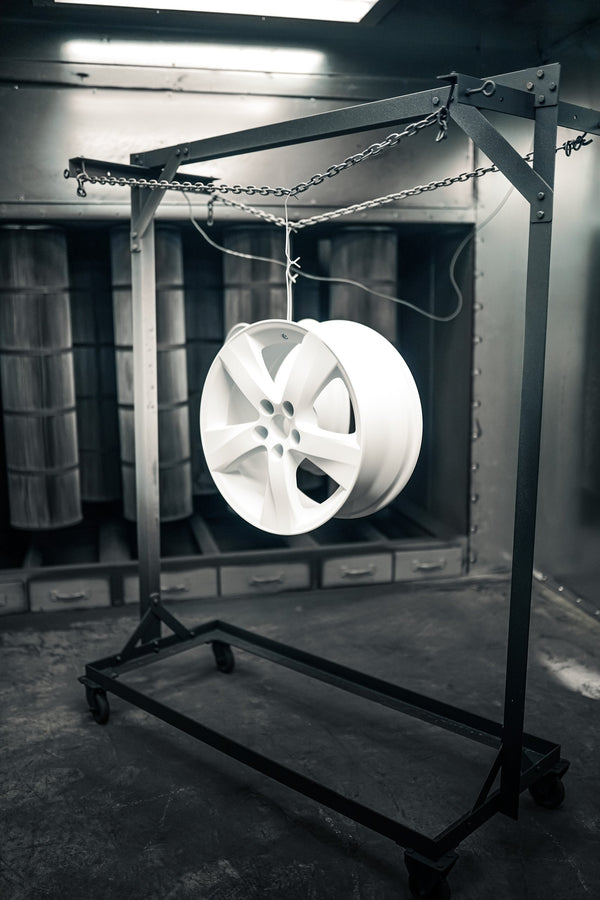Purple powder-coated wheel in the spray booth